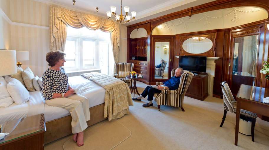 Victoria Hotel Couple Relaxing in Room with Cup of Tea