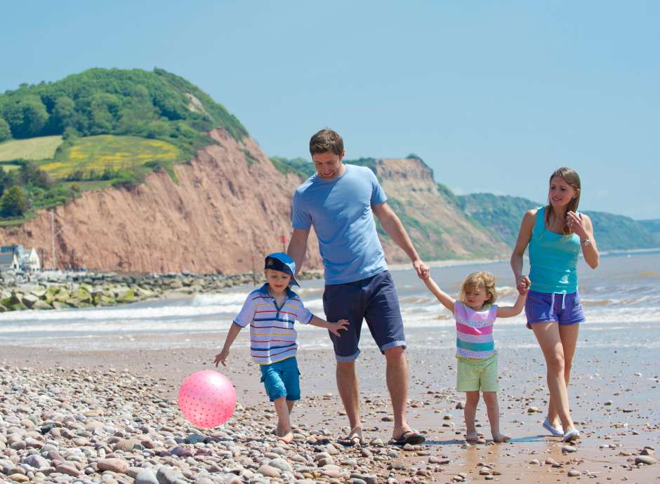 Family Walking at Sidmouth Sea Front in Summer
