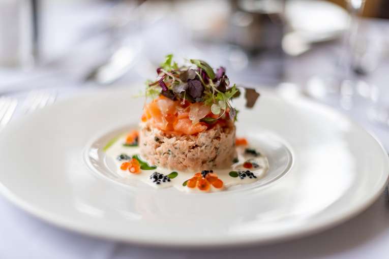 Salmon dish on a white plate in The Jubilee Restaurant